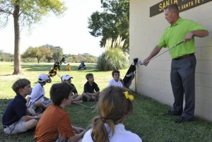 Mr. Gaestel teaching junior golfers.